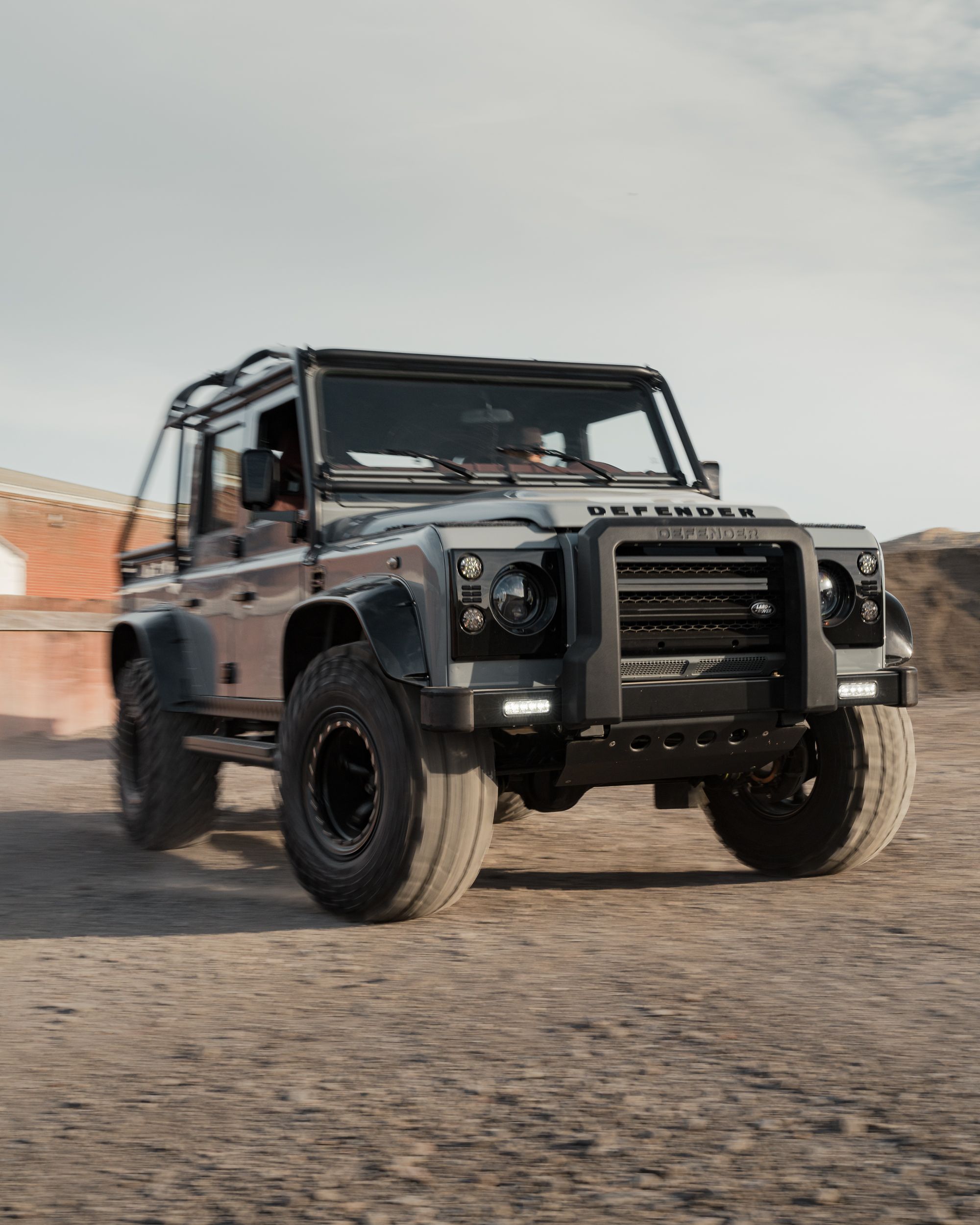 Restored Defender in motion with no number plate fitted